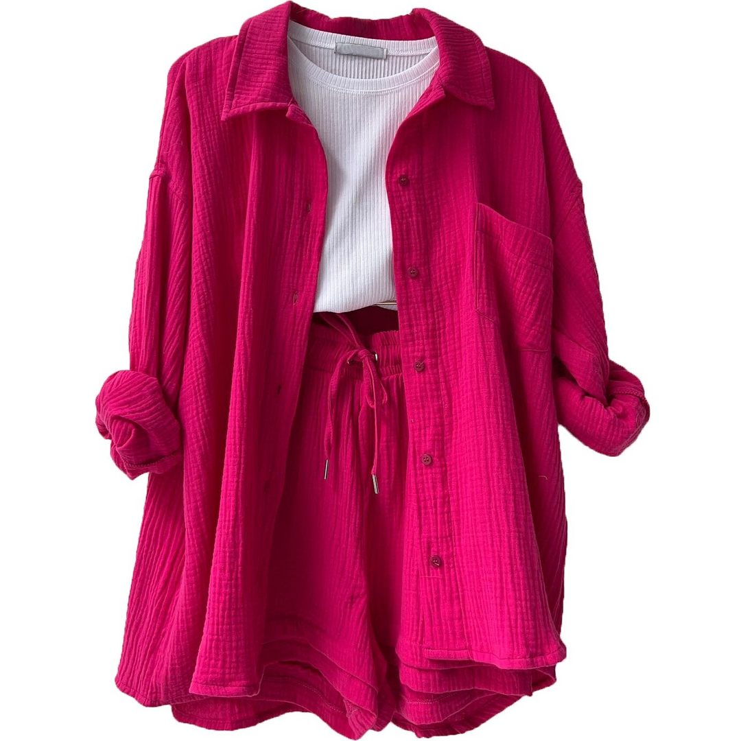 A woman wearing a relaxed button shirt with matching drawstring shorts, fresh and easy.