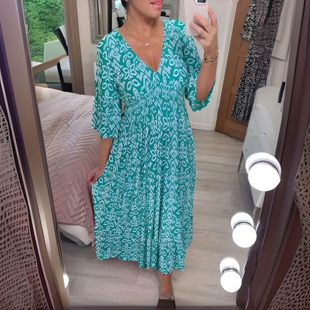 Woman wearing the Danielle™ bold printed boho maxi dress with a V-neckline, smiling outdoors in the sunshine.