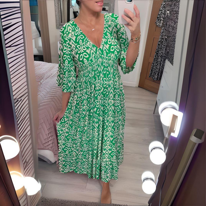 Woman wearing the Danielle™ bold printed boho maxi dress with a V-neckline, smiling outdoors in the sunshine.