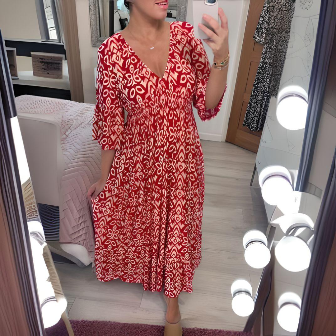 Woman wearing the Danielle™ bold printed boho maxi dress with a V-neckline, smiling outdoors in the sunshine.