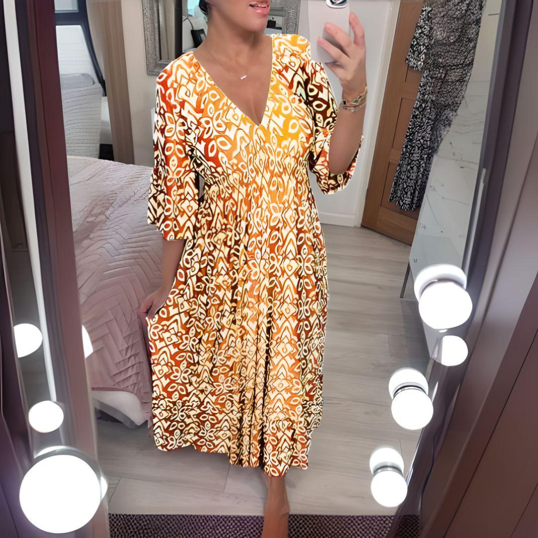 Woman wearing the Danielle™ bold printed boho maxi dress with a V-neckline, smiling outdoors in the sunshine.
