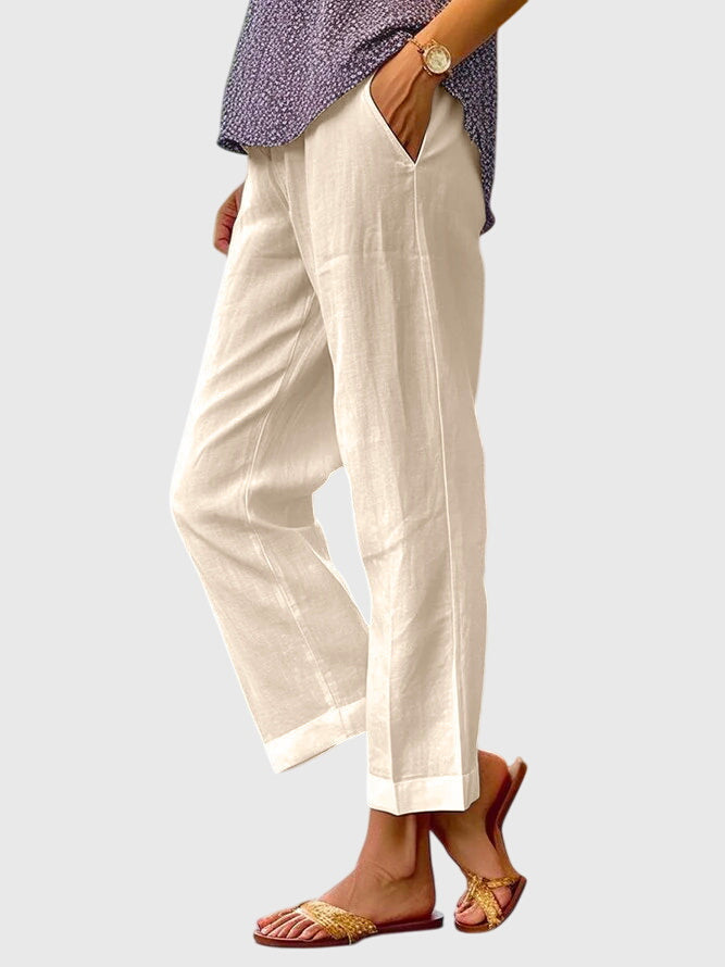 A woman wearing elegant tailored pants with a flattering straight-leg cut and clean lines.