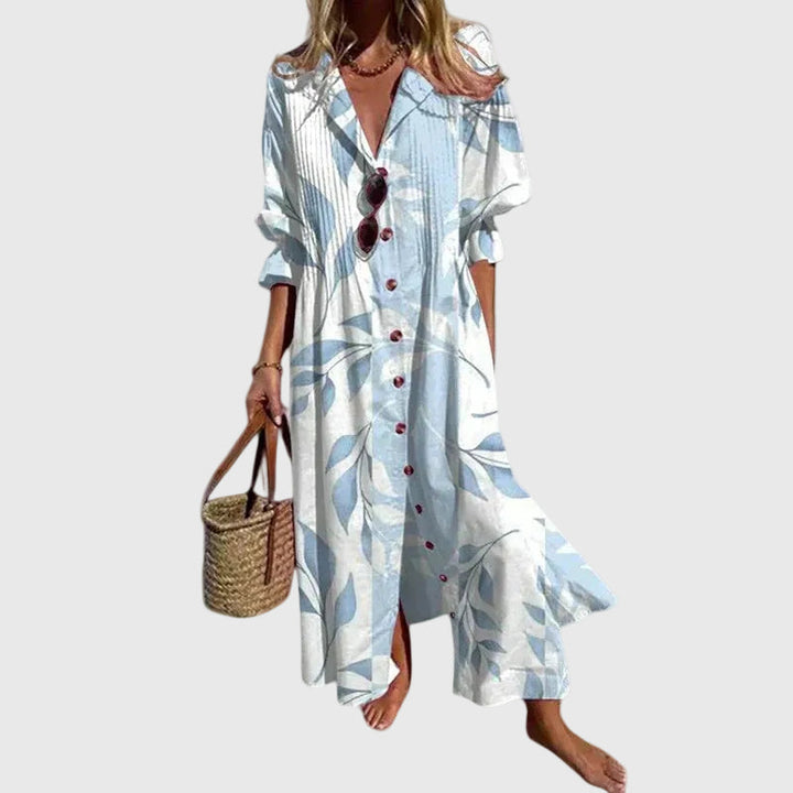 Woman in a long flowing boho-style maxi dress with delicate patterns, walking outdoors.