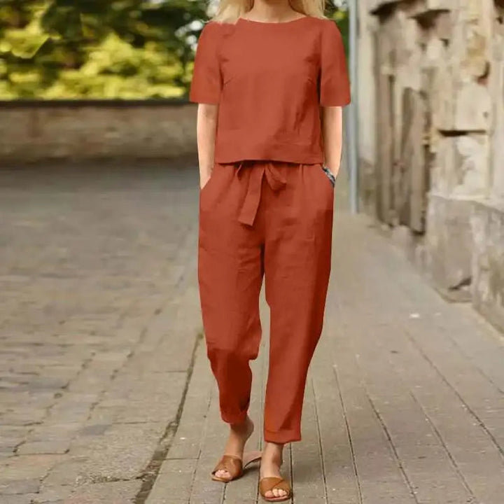 A woman wearing a relaxed short-sleeve top and matching drawstring pants lounge set.
