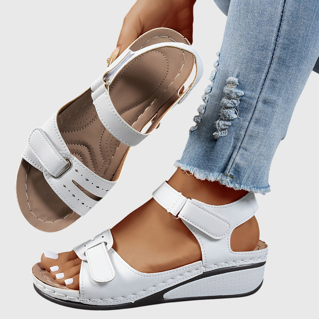 A woman wearing wide-fit supportive sandals with a relaxed summer outfit, walking with ease and confidence.