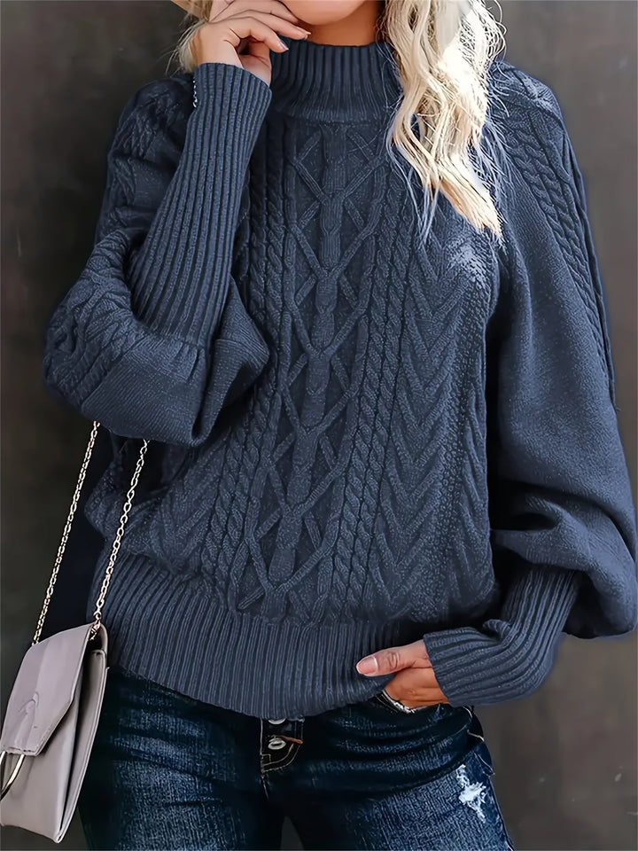 A woman wearing a long, relaxed sweater with long sleeves, soft and cosy for everyday wear.