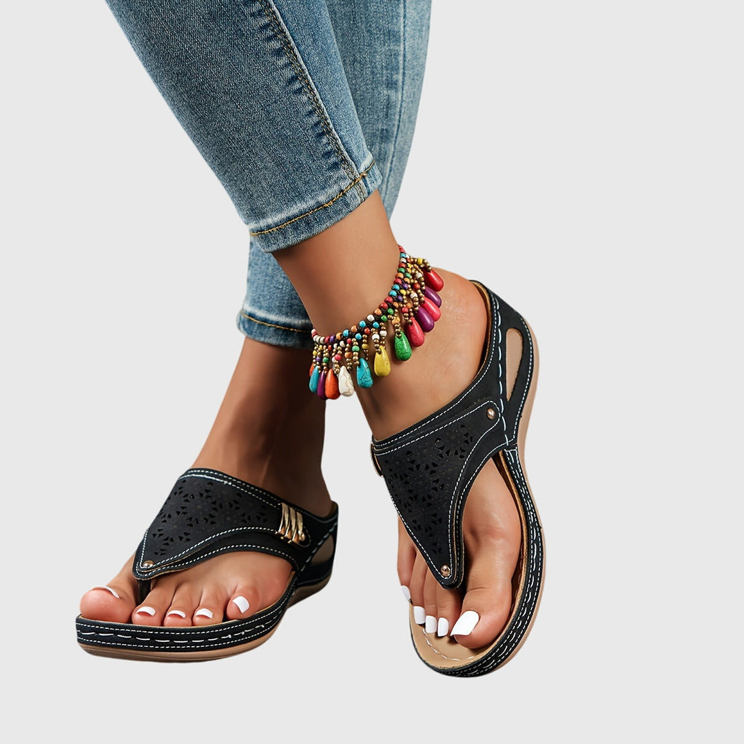 A woman in grey comfort flip-flops relaxing outdoors, feet cushioned and supported.