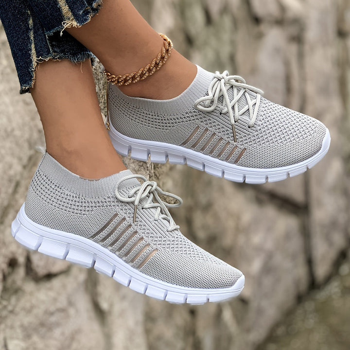 A woman wearing light breathable sock-style comfort shoes