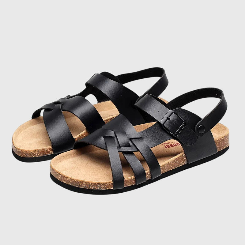 A woman in colourful cross-strap summer sandals with an adjustable ankle buckle on a warm day.