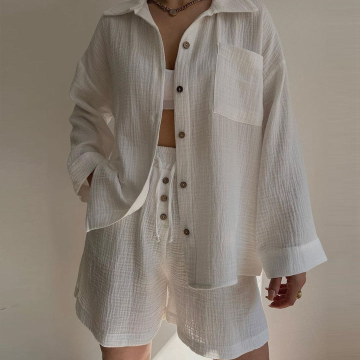 A woman wearing a flowing oversized shirt with drawstring shorts, relaxed and breezy.