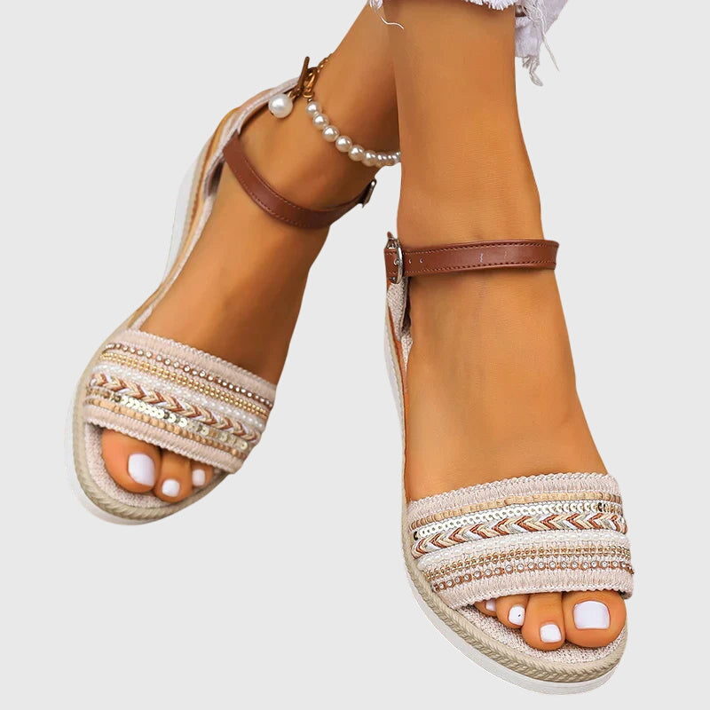 A woman walking easily in lightweight modern sandals in a soft white and brown finish.