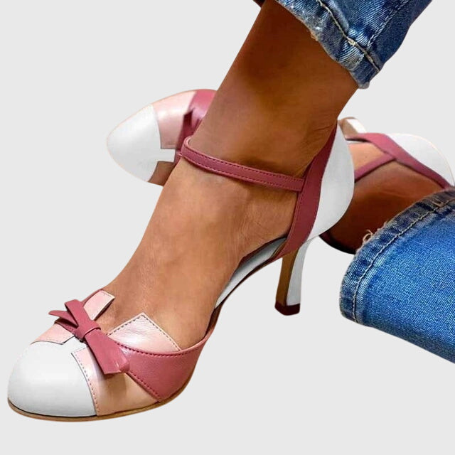 A woman wearing feminine heeled sandals with a summer occasion outfit