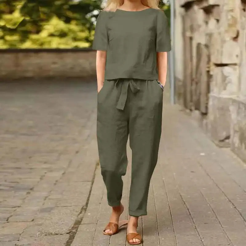 A woman wearing a relaxed short-sleeve top and matching drawstring pants lounge set.