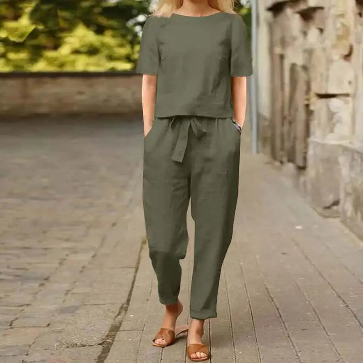 A woman wearing a relaxed short-sleeve top and matching drawstring pants lounge set.