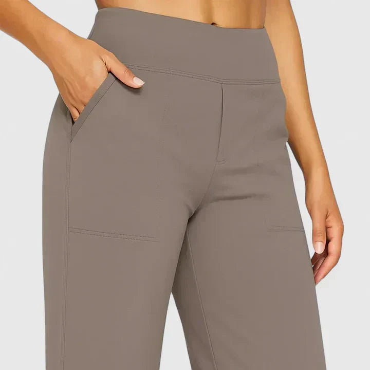 A woman in tailored pants styled with a simple top for an elegant, comfortable everyday look.
