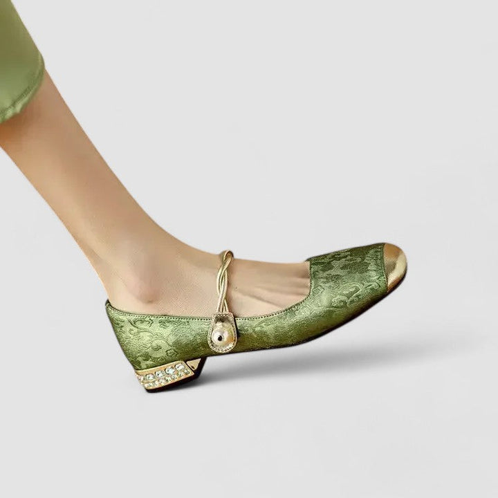 A woman wearing embellished green Mary Jane flats at a special occasion.