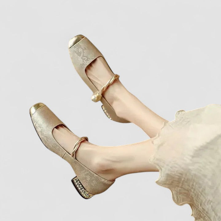 A woman wearing embellished green Mary Jane flats at a special occasion.