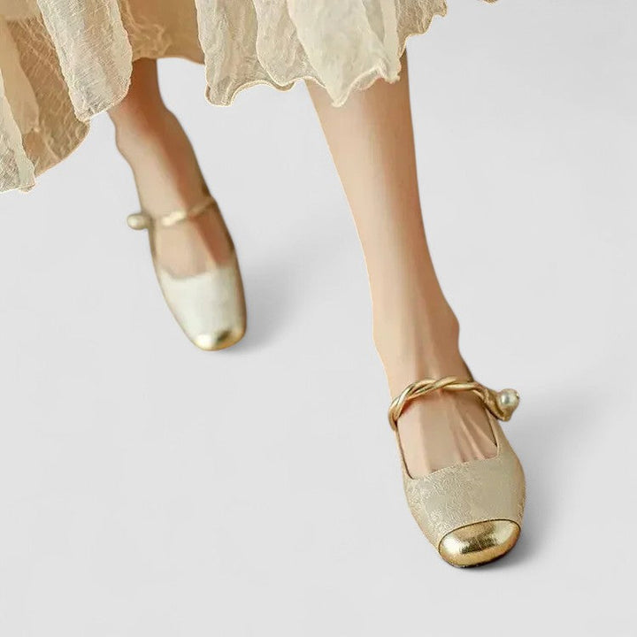 A woman in sparkling Mary Jane shoes with a low block heel at an evening celebration.