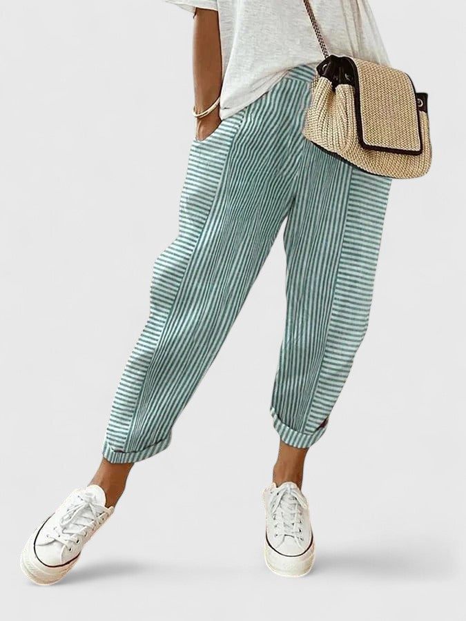 A woman wearing airy comfy summer pants with an elastic waist and side pockets.