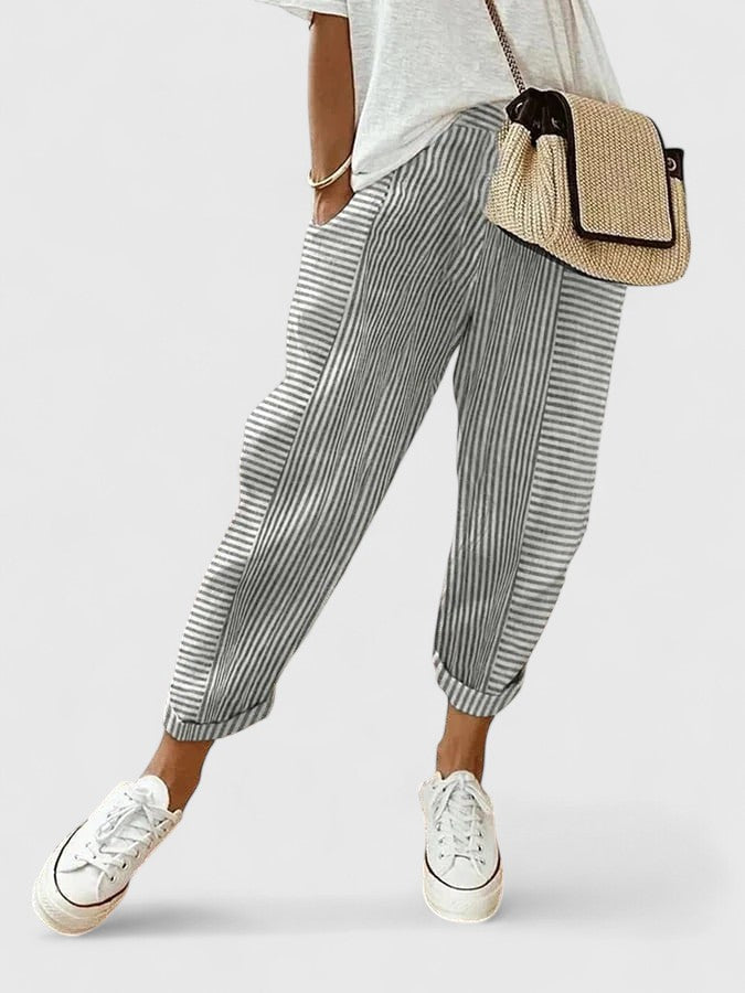 A woman wearing airy comfy summer pants with an elastic waist and side pockets.