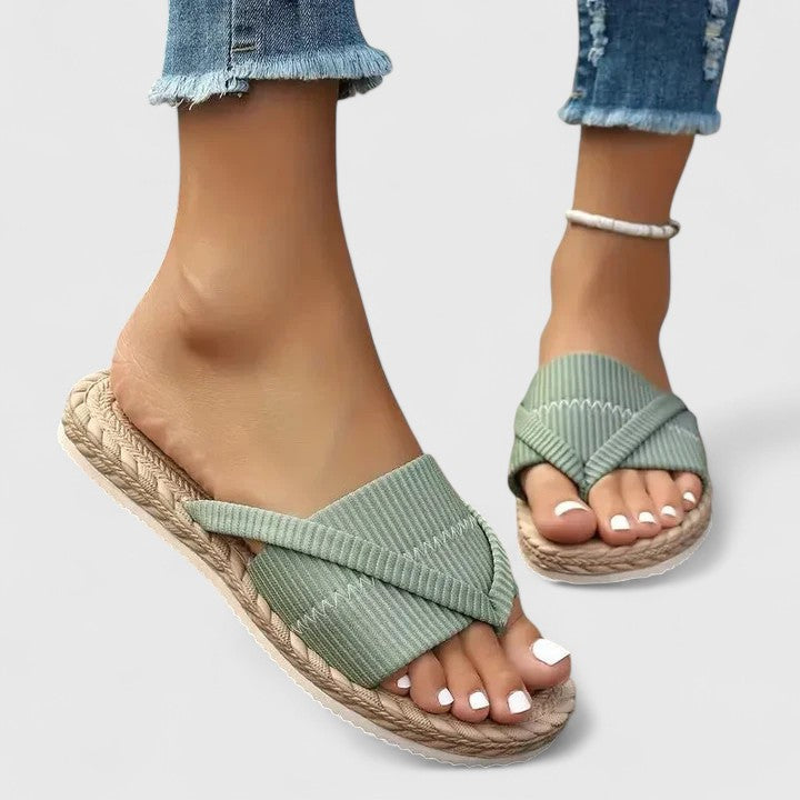 A woman moving freely in wide-fit open-front support sandals with a cushioned footbed.