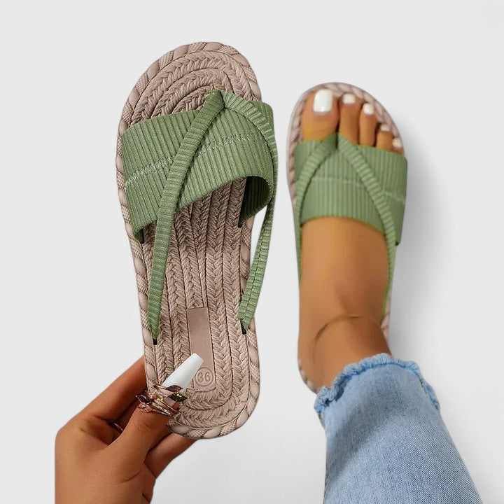 A woman moving freely in wide-fit open-front support sandals with a cushioned footbed.