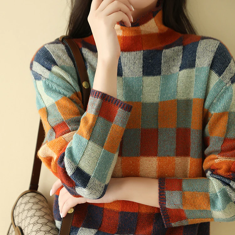 A woman wearing a colourful retro check sweater, relaxed and cosy on a cool fall morning.
