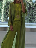 A woman wearing a flowing three-piece set with a sleeveless top, wide pants and a long cardigan.