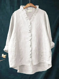 Woman wearing a plain ruffle-front summer blouse with a soft, flowing silhouette.