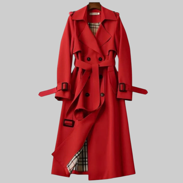 A woman wearing a belted classic trench coat with a defined waist, walking through the city.