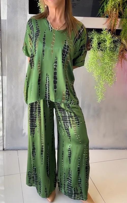 A woman wearing a vivid printed matching top and pants set.
