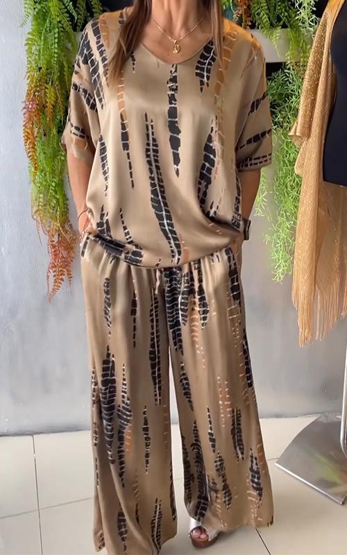 A woman wearing a vivid printed matching top and pants set.