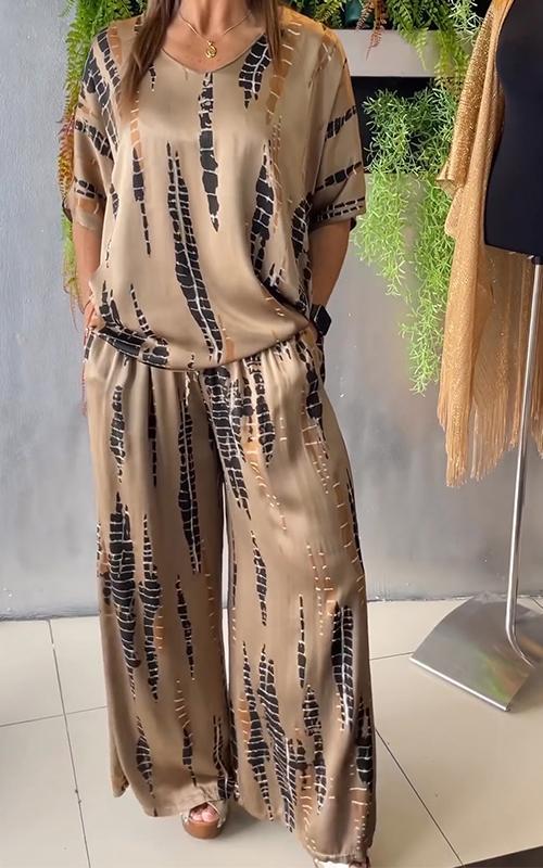 A woman wearing a vivid printed matching top and pants set.