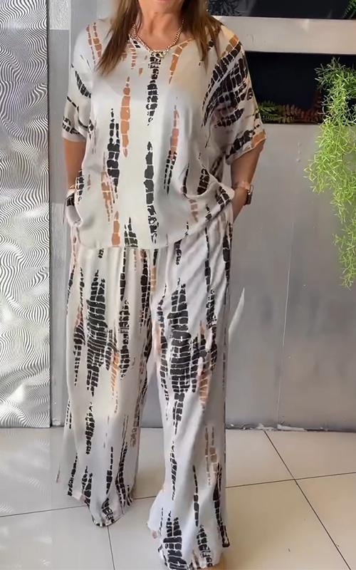 A woman wearing a vivid printed matching top and pants set.