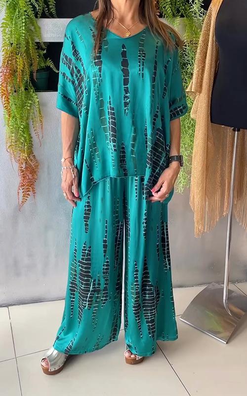 A woman wearing a vivid printed matching top and pants set.