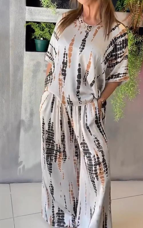 A woman wearing a vivid printed matching top and pants set.