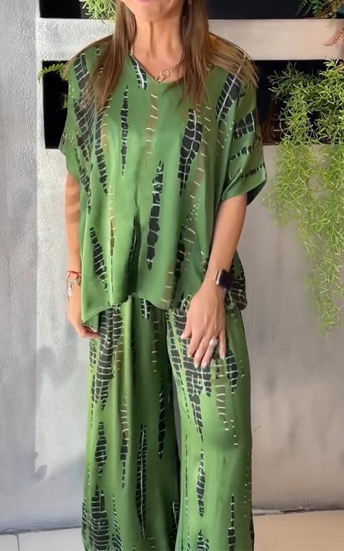 A woman wearing a vivid printed matching top and pants set.