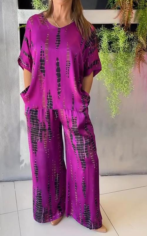 A woman wearing a vivid printed matching top and pants set.