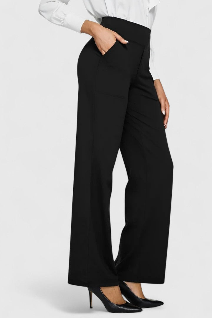 Woman wearing pull-on pants with a soft blouse, relaxed and comfortable at home.
