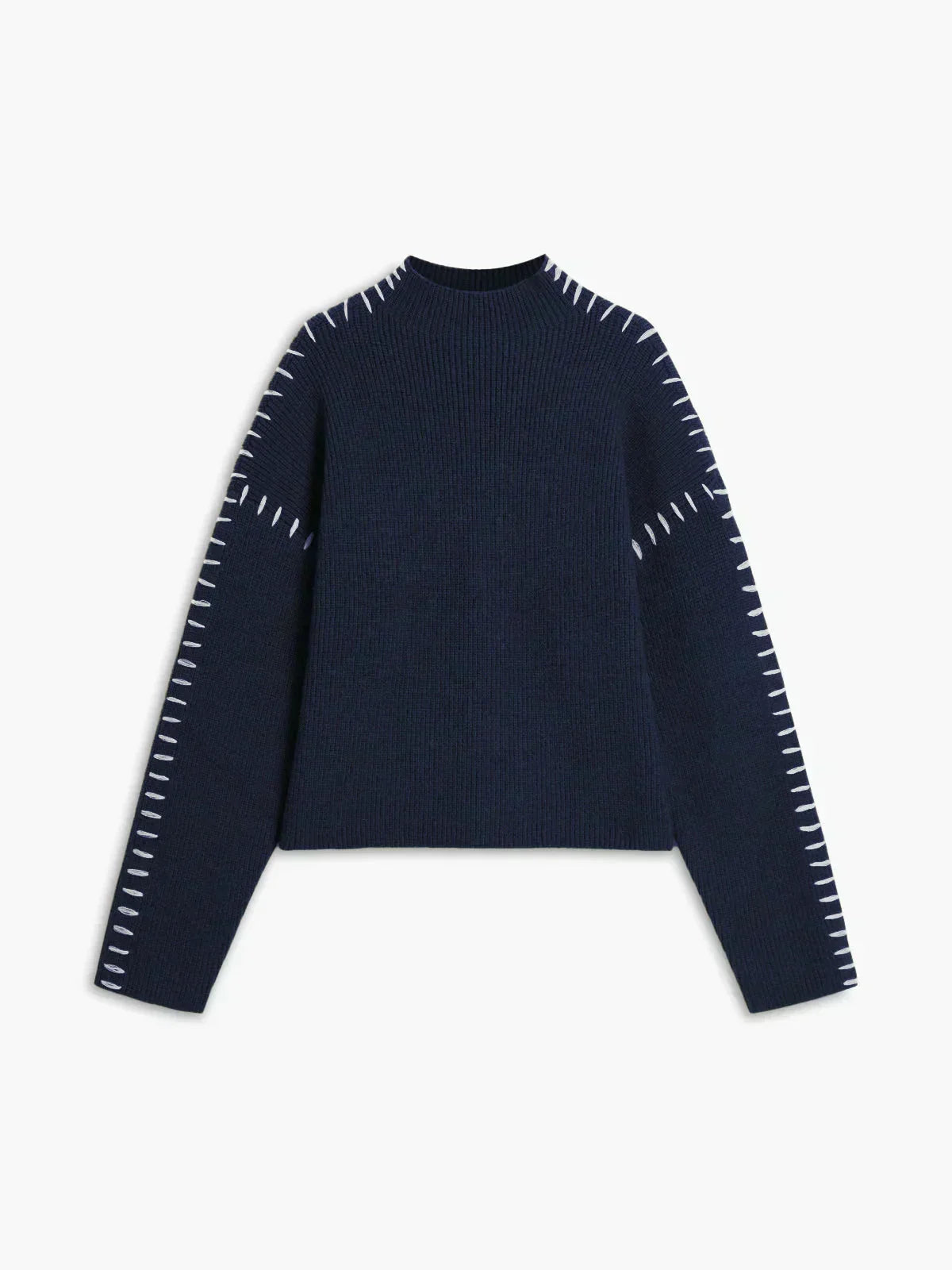 A woman wearing an oversized mock-neck sweater with whipstitch detailing, cosy and stylish.