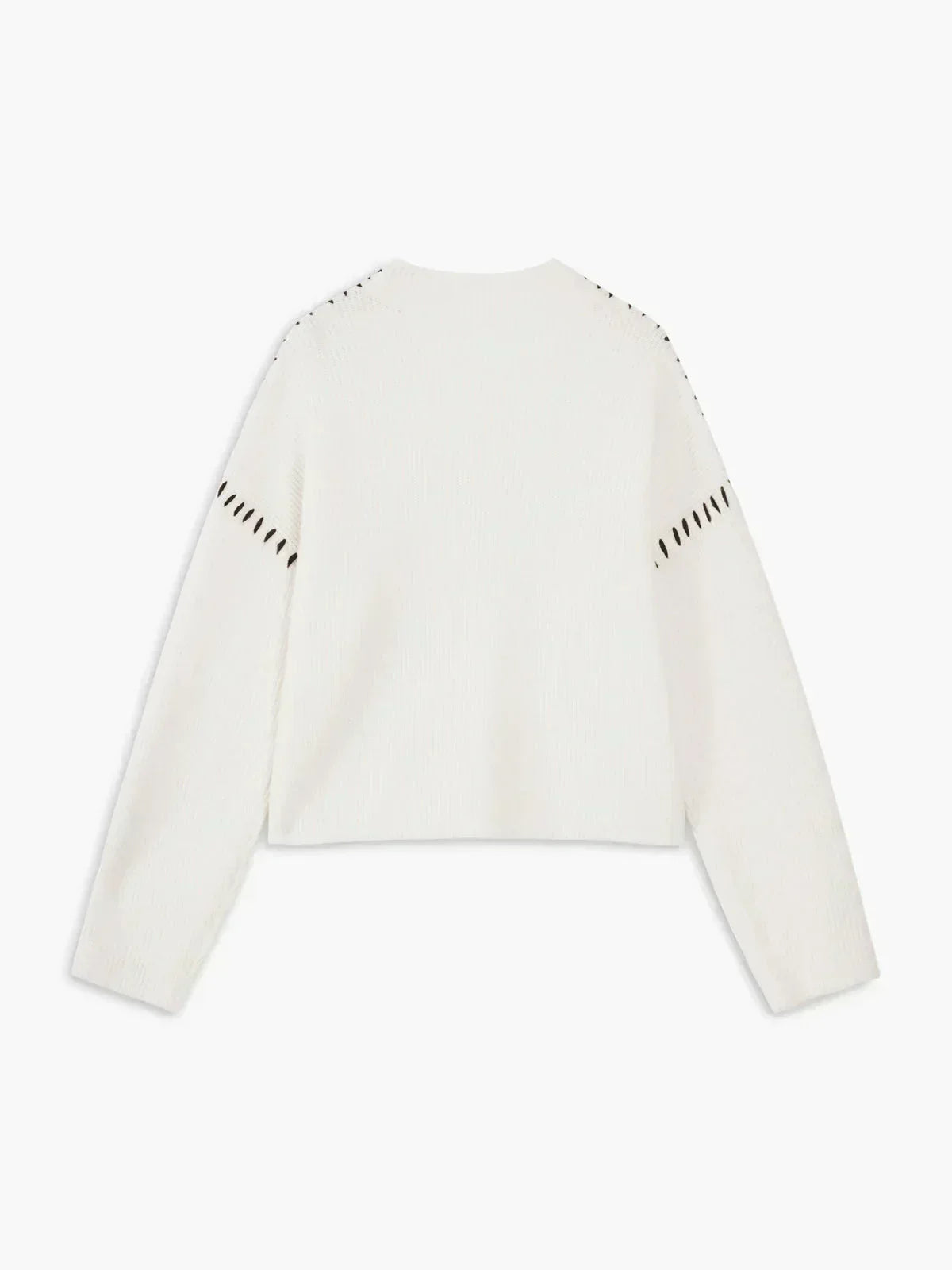 A woman wearing an oversized mock-neck sweater with whipstitch detailing, cosy and stylish.