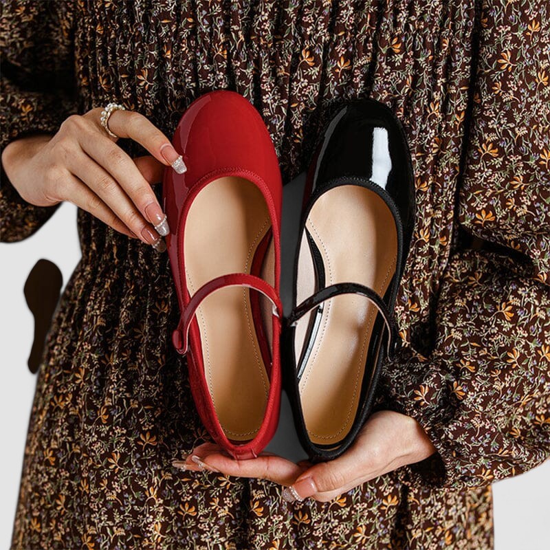 A woman wearing glossy black Mary Jane shoes with a low block heel, comfortable and steady during a day of errands.