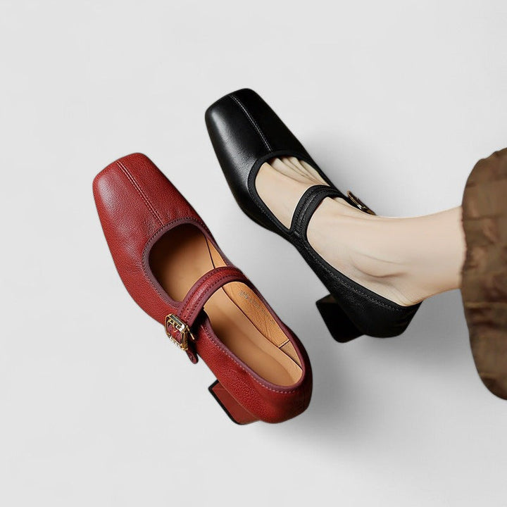 A woman in black Mary Jane shoes with a mid block heel, confident on an evening out.