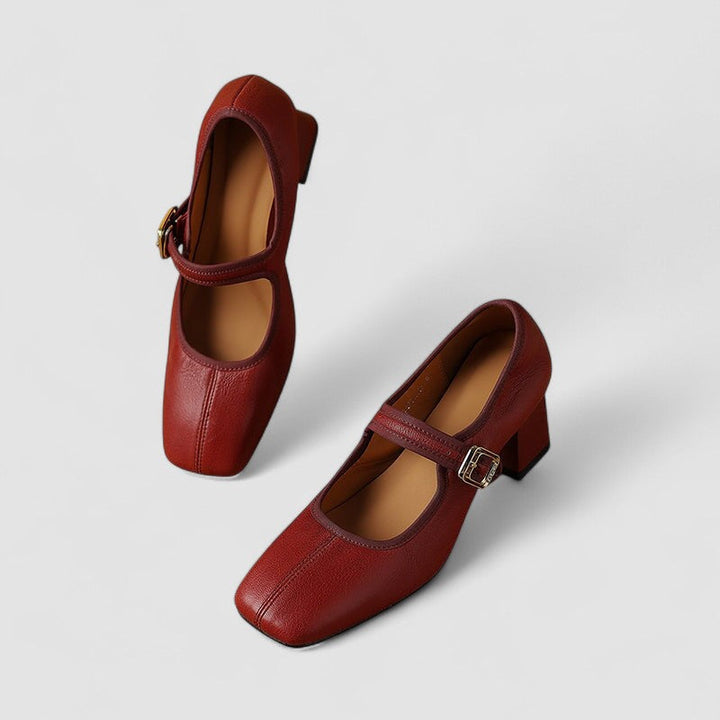 A woman in black Mary Jane shoes with a mid block heel, confident on an evening out.