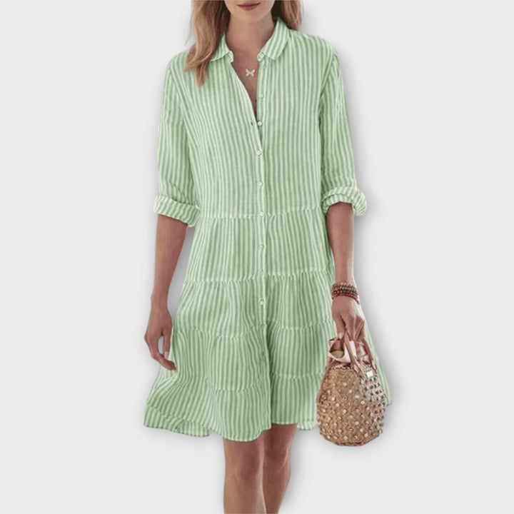 Woman wearing the Renee™ striped button-through shirt dress with roll-up sleeves, walking outdoors in the sunshine.