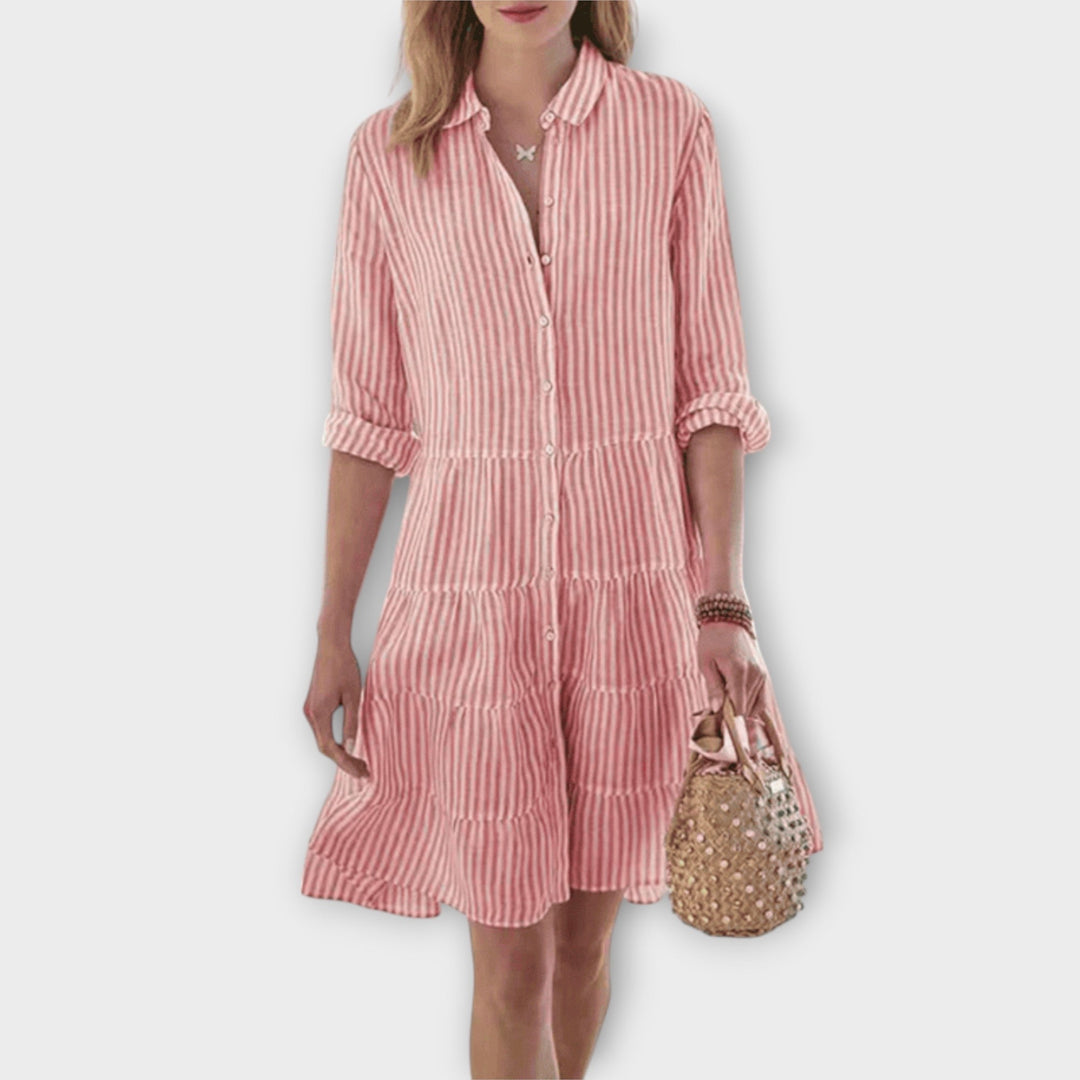 Woman wearing the Renee™ striped button-through shirt dress with roll-up sleeves, walking outdoors in the sunshine.