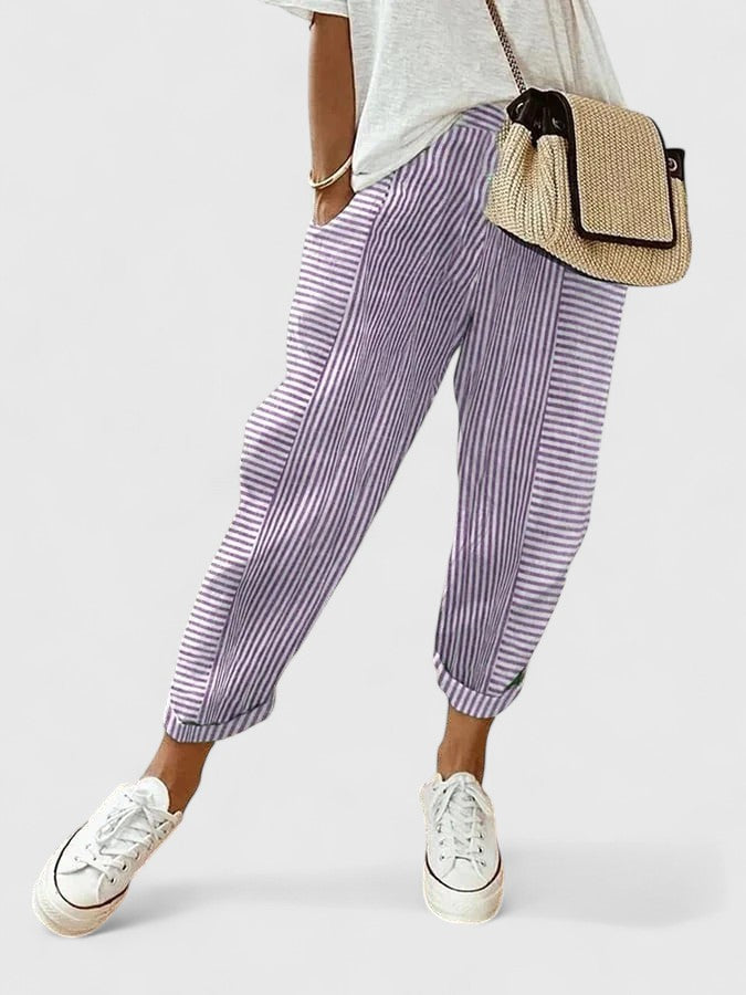 A woman wearing airy comfy summer pants with an elastic waist and side pockets.