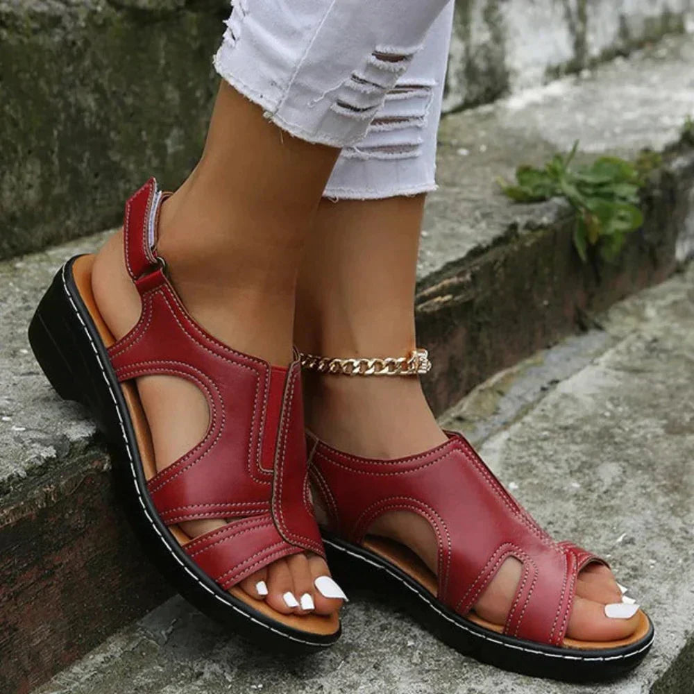 A woman wearing supportive heeled sandals with a summer dress, walking comfortably and looking relaxed.