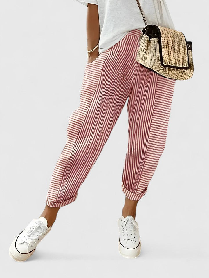 A woman wearing airy comfy summer pants with an elastic waist and side pockets.