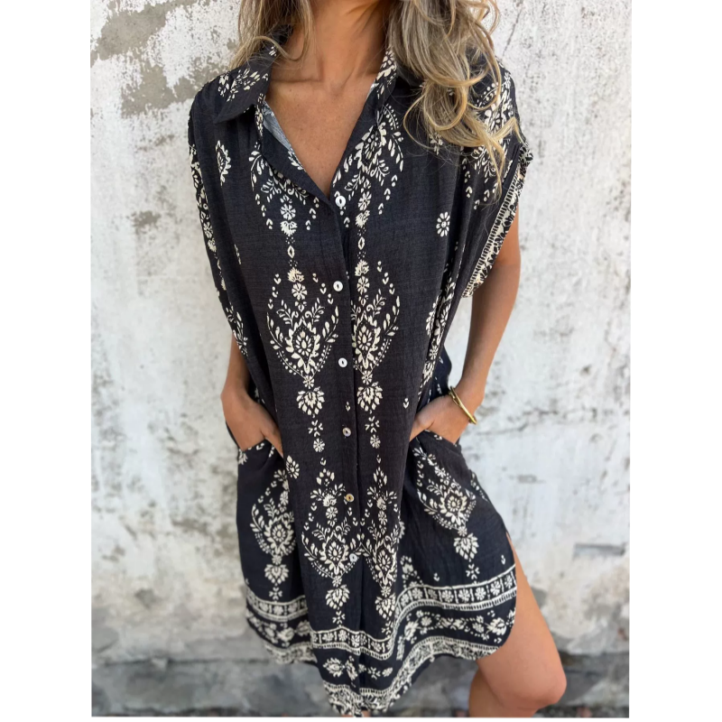 Woman wearing the Isabelle vintage print shirt dress with a button front and soft collar, standing in warm daylight.